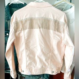 Vintage light pink Levi’s denim jacket with rhinestone fringe